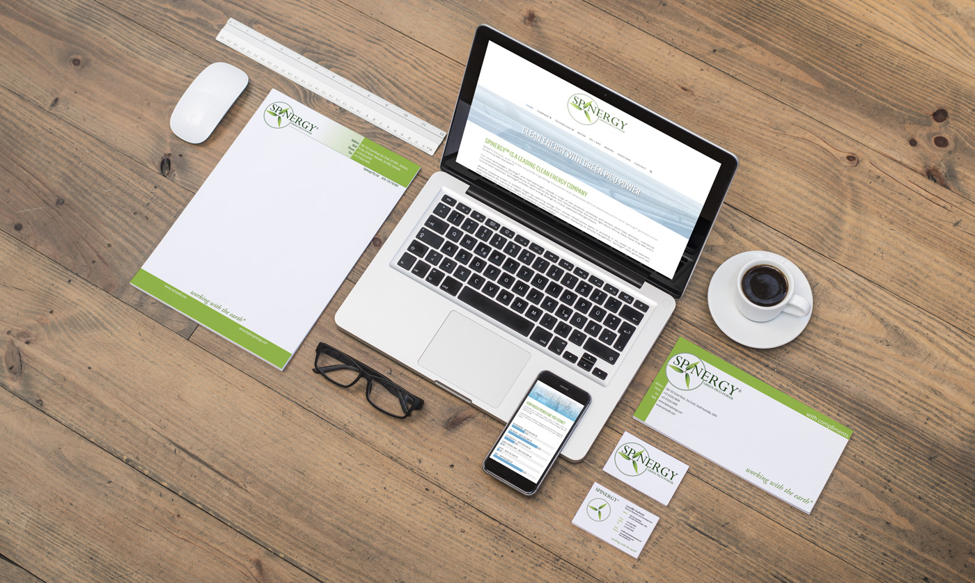 Spinergy - stationery and website on wooden floor